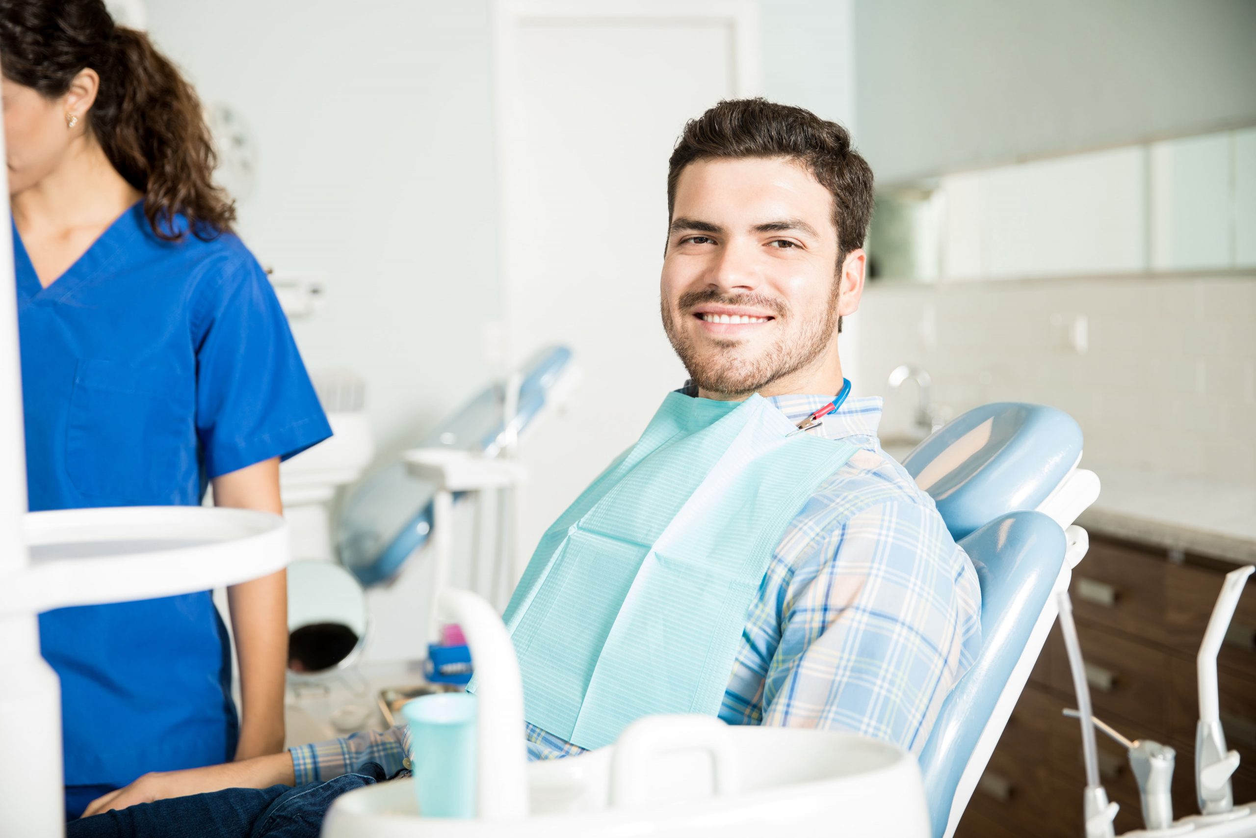 https://dental.harbors.in/wp-content/uploads/2024/01/portrait-smiling-man-sitting-chair-while-female-dentist-working-clinic-scaled.jpg